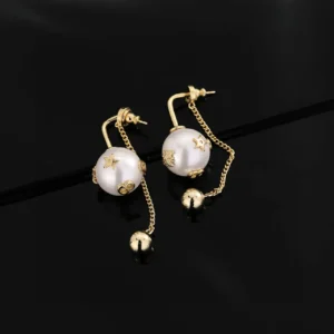 Dior Letter Pearl Earrings featuring gold accents and a unique design, showcased against a dark background, highlighting their elegance and craftsmanship.