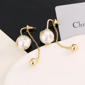 Dior Letter Pearl Earrings featuring gold accents and pearl-like beads, displayed on a neutral background with a brand card.