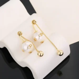 Dior Letter Pearl Earrings featuring elegant gold chains and pearl accents, displayed on a soft background, emphasizing their luxurious design and craftsmanship.