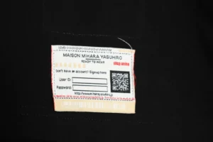 Maison Mihara Yasuhiro ready to wear black fabric clothing label with QR code and website details