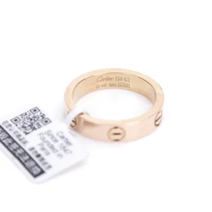 Cartier LOVE Series Ring in rose gold, featuring iconic screw motifs and engraved branding, with a product tag indicating authenticity and size options.