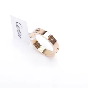 Cartier LOVE Series Ring in rose gold with signature logo tag, showcasing luxury replica jewelry craftsmanship.