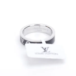 Louis Vuitton LV x Nigo co-branded enamel ring with a silver band and black enamel, featuring engraved logo and attached tag.