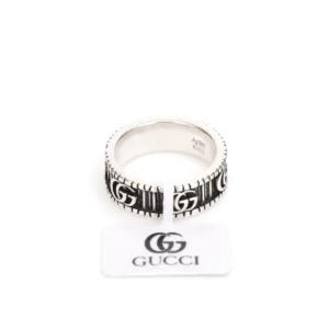 Gucci Double G silver ring with black detailing and logo, displayed on a white background.