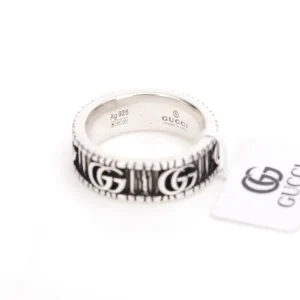 Gucci Double G silver ring featuring black enamel detailing and logo, with product tag visible.
