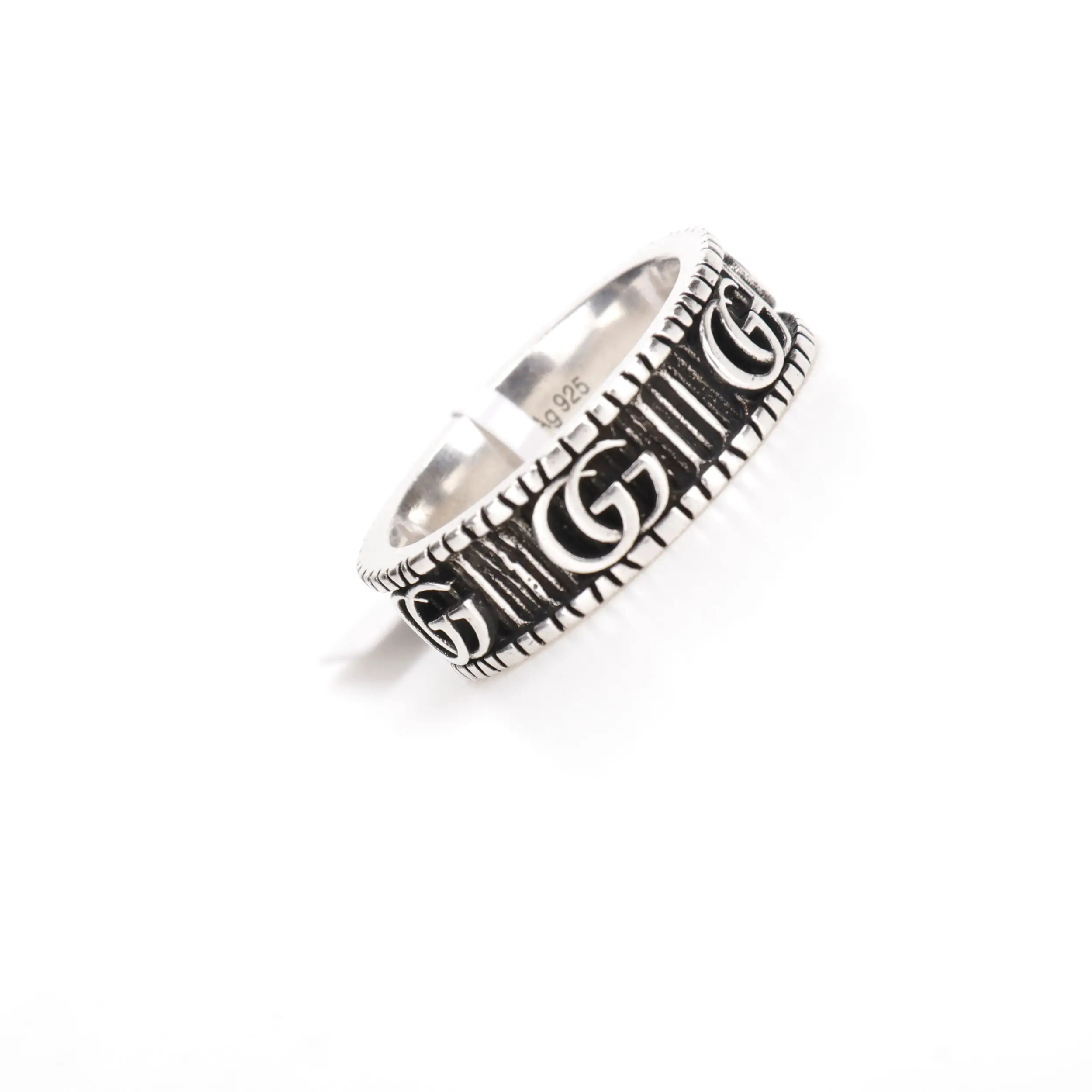 Gucci Double G silver ring featuring intricate design and engraved logos, available in various sizes for men and women.