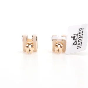 HERMES Love Magic Square Enamel Earrings featuring polished H-enamel surfaces and gold accents, showcasing luxury craftsmanship and original branding tag.
