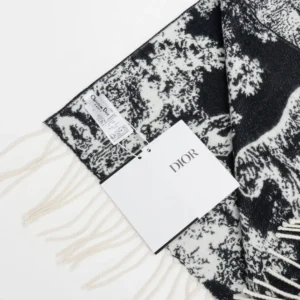 Dior Sauvage Zoo Tassel Long Wool Scarf featuring intricate black and white patterns, cashmere material, and a designer tag, showcasing luxury fashion accessory details.