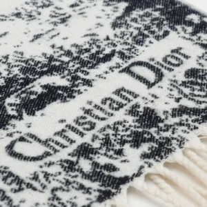 Dior Sauvage Zoo Tassel Long Wool Scarf featuring a black and white pattern with "Christian Dior" logo, highlighting luxury fashion accessory details.