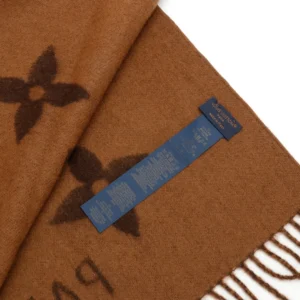 Louis Vuitton Printed Cashmere Fringe Scarf in brown with iconic logo pattern and care label, luxury winter accessory.