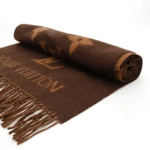 Louis Vuitton Printed Cashmere Fringe Scarf featuring iconic logo and fringe detailing, luxurious brown fabric, ideal for winter accessories.