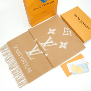 Louis Vuitton Printed Cashmere Fringe Scarf displayed with packaging, featuring iconic LV logo and design elements, emphasizing luxury fashion accessory.