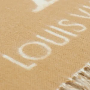 Close-up of Louis Vuitton Printed Cashmere Fringe Scarf showcasing logo detail and fringe texture, emphasizing luxury fashion accessory.