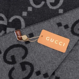 Gucci Big GG Double-Sided Jacquard Long Scarf featuring prominent GG logo pattern and brand tag, highlighting luxury designer accessory.