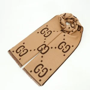 Gucci GG Large Logo Jacquard Wool Scarf in beige, featuring prominent GG logo design, double-sided print, and fringed edges, showcased as a luxury accessory for sale.
