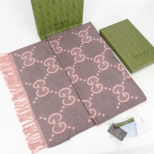 Gucci Big GG Double-Sided Jacquard Long Scarf featuring a pink and gray design, accompanied by branded packaging and tags, emphasizing luxury fashion accessories.