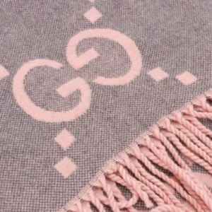 Gucci Big GG Double-Sided Jacquard Long Scarf featuring pink logo detail and fringe edges, designed for luxury fashion enthusiasts.