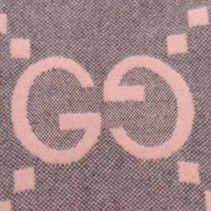 Gucci Big GG logo detail on a double-sided jacquard scarf, highlighting luxury fashion design elements.