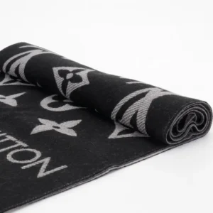Louis Vuitton Printed Long Scarf rolled, featuring iconic logo design in black and grey, showcasing luxury craftsmanship and style.