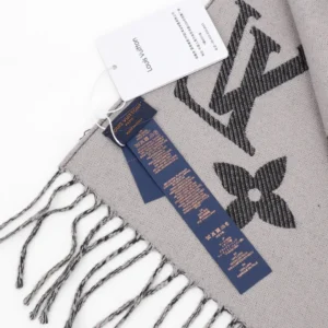Louis Vuitton Printed Long Scarf with logo detail and care tags, showcasing luxurious craftsmanship and design, ideal for accessory enthusiasts.