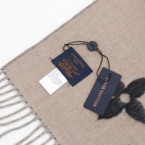 Louis Vuitton gradient cashmere fringe scarf with tags, showcasing luxury branding and fabric details.