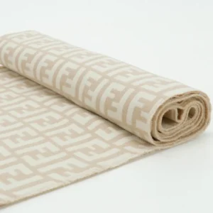 Fendi FD Old Flower Small FF Tassel Long Scarf rolled up, featuring a beige background with a repeating logo pattern, showcasing luxurious cashmere and wool material.