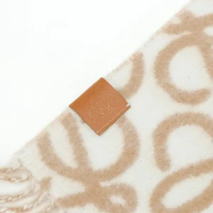Loewe Double-Sided Floral Jacquard Wool Mohair Fringe Long Scarf featuring a beige and cream pattern with a leather logo tag.