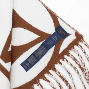 Louis Vuitton Mahjong Double Sided Wool Cashmere Tassel Scarf featuring a brown and white design, with a label displaying care instructions and product details.
