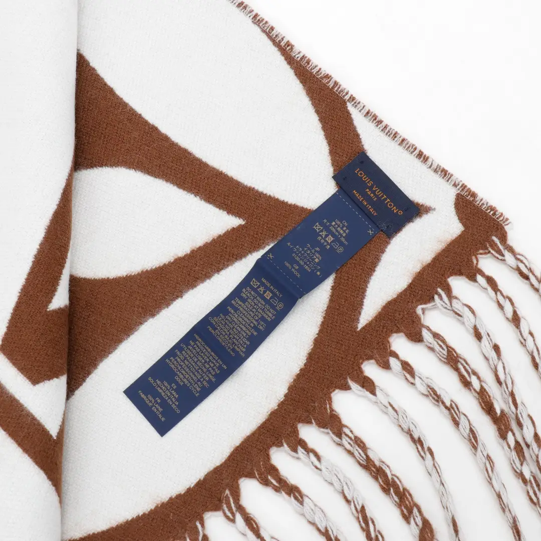Louis Vuitton Mahjong Double Sided Wool Cashmere Tassel Scarf featuring a brown and white design, with care label displayed.