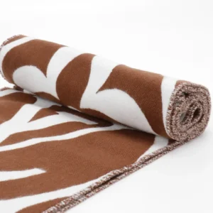 Louis Vuitton Mahjong Double Sided Wool Cashmere Tassel Scarf rolled with brown and white design, showcasing luxury replica fabric.