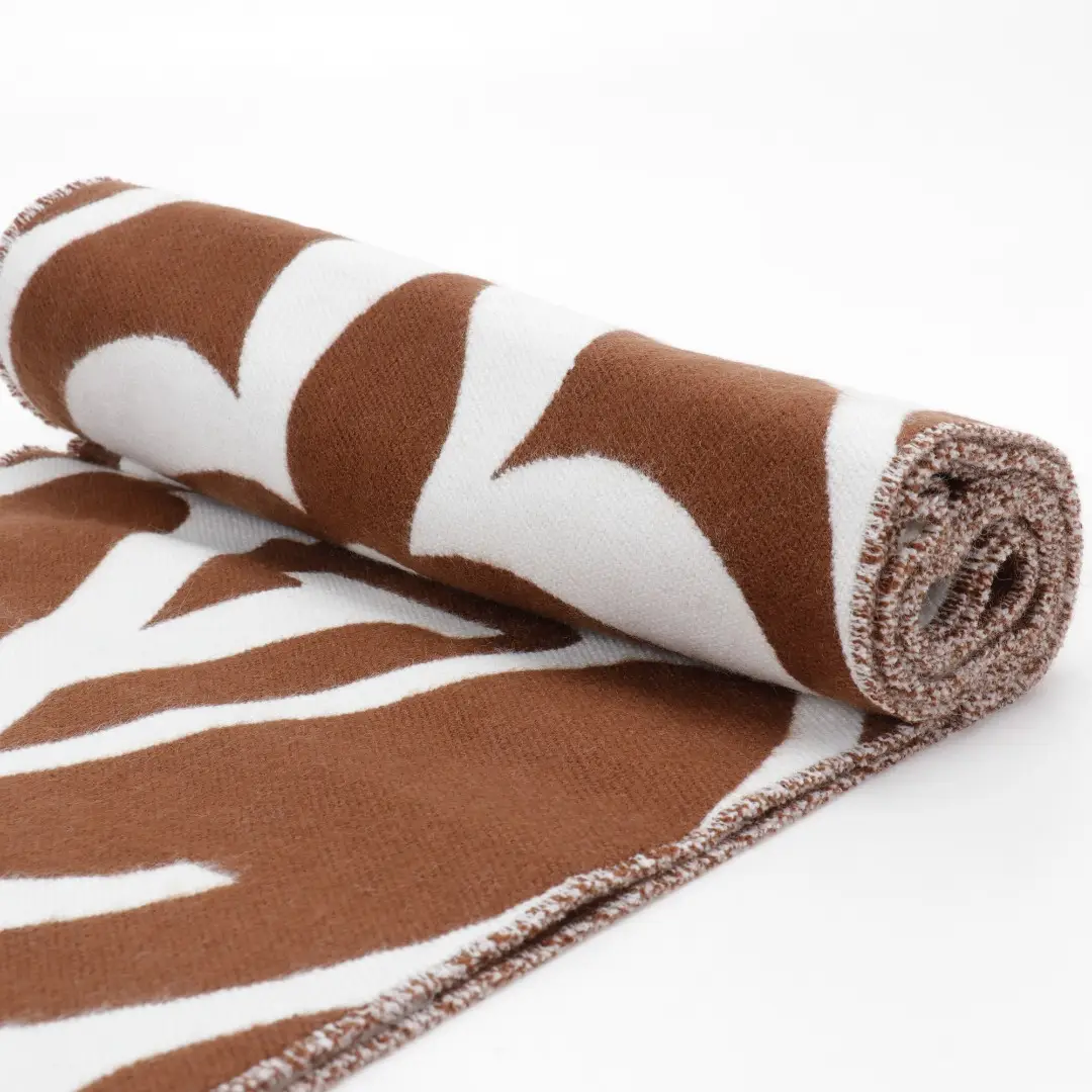 Louis Vuitton Mahjong Double Sided Wool Cashmere Tassel Scarf in brown and white, showcasing intricate design and luxurious fabric texture, ideal for stylish layering.