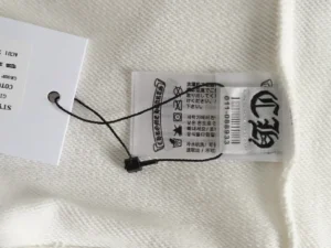 Chrome Hearts hoodie tag showing brand logo and care instructions, emphasizing premium quality and authenticity for fashion-conscious consumers.