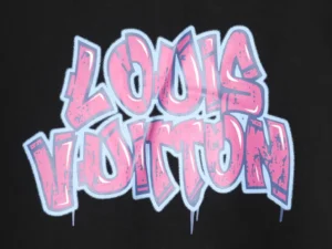 Louis Vuitton graffiti logo in pink and blue on black hoodie fabric, showcasing luxury streetwear design.