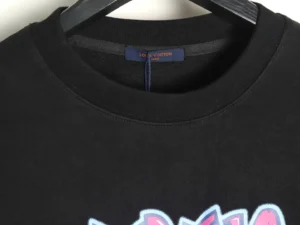 Black Louis Vuitton hoodie featuring colorful graffiti lettering, round neck design, and brand tag visible on the inside collar.