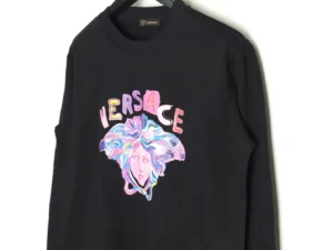 Versace painted sequins Medusa sweatshirt featuring colorful graphic design on black fabric, showcasing luxury replica apparel.