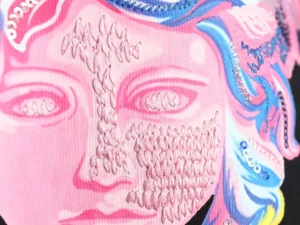Versace Painted Sequins Medusa design featuring intricate embroidery and vibrant colors on a sweatshirt fabric.