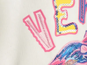 Repsgoat embroidered sequined applique patch pink yellow blue fabric detail