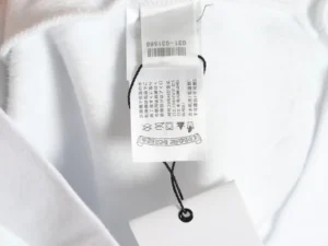 Chrome Hearts white cotton fabric clothing care label with black printed instructions and barcode tag