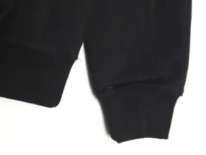 Black cuff detail of the Dior Embroidered Silver Label Hoodie, showcasing high-quality fabric and stitching.