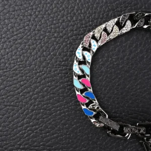 Louis Vuitton Chain Letter embellished bracelet featuring colorful enamel accents and artificial crystals on large flat chain links, set against a black leather background.