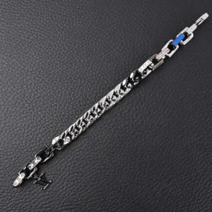 Louis Vuitton Chain Letter Embellished Colorful Hands bracelet featuring large flat chain links, metal, enamel, and artificial crystals on a textured black background.