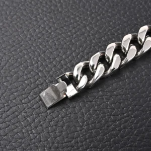 Unknown brand silver chain bracelet stainless steel curb link with box clasp on black textured background