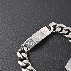 Louis Vuitton bracelet silver-tone metal engraved logo chain accessory on black surface