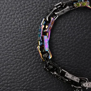 Multi-colored patchwork pendant bracelet with matte, polished, and glossy metal links, featuring Louis Vuitton branding, displayed on a textured black background.