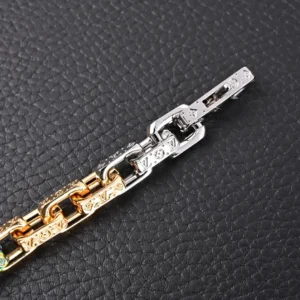 Multi-colored patchwork pendant bracelet replica from Louis Vuitton, featuring matte, polished, and glossy metal construction with LV letters, on a textured black background.