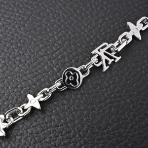 Louis Vuitton Monogram Craggy Chrysanthemum bracelet featuring glossy brass links and LV logo, designed for stylish accessory pairing.