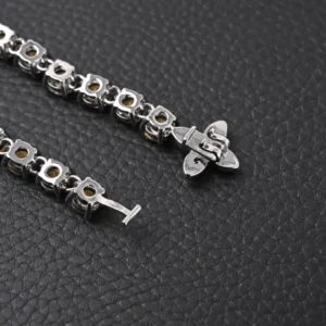 Chrome Hearts bracelet silver metal chain with flower links and signature cross clasp on black textured background