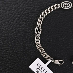 Gucci bracelet silver chain link sterling silver with interlocking G logo charms and lobster clasp closure