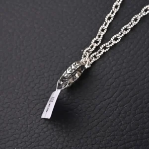Gucci GUC 3D Double G Pure Silver Pendant Necklace featuring intricate design and textured chain on a dark background.