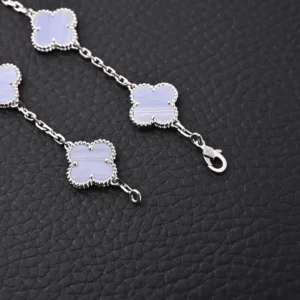 Van Cleef & Arpels Blue Jadeite Bracelet featuring smooth four-leaf petal-shaped blue jadeite elements, S925 silver chain, and lobster clasp, showcasing elegant craftsmanship and premium materials.